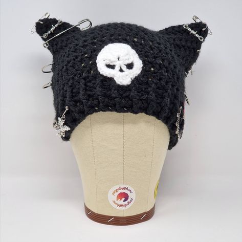 🧶 crochet hat in super soft yarn in Black with cat ears! And a skull! and safety pins!

🧶 The safety pins, pin badges and chain can all be removed or repositioned.

🧶 24cm across at the the brim, 17cm from peak to edge Cat Ear Crochet Hat, Cat Crochet Hat, Black Cat Beanie, Crochet Cat Ear Hat, Crochet Cat Ears, Cat Hat Crochet, Chunky Knit Crochet, Crochet Cat Ear Beanie, Cat Ear Hat