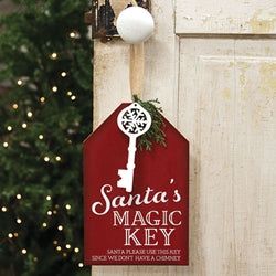 Santa's Magic Key Gift Tag Holder is a charming wooden sign made with festive antique-inspired style. Perfect for traditional or farmhouse holiday decor, the red sign features a geometric shape accented by a wooden key cutout, sprig of artificial greens, and burlap hanging ribbon. A mix of print, script, and block lettering reads "Santa's magic key. Santa, please use this key since we don't have a chimney." Measures 10" high by 6.25" wide by .125" deep. Santa’s Magic Keys, Santa Christmas Tags, Farmhouse Holiday Decor, Santa Chimney, Floral Candle Rings, Santa Key, Wreath Stand, Christmas Craft Show, Key Decorations