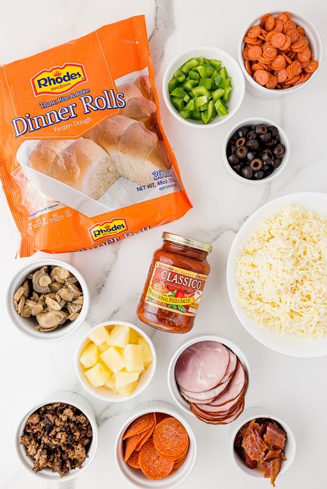 ingredients for mini pizzas on a white marble countertop, including meats, olives, cheese, a package of Rhodes frozen dinner rolls and Classico traditional pizza sauce Pizza Bread Rolls, Recipes Using Frozen Dinner Roll Dough, Rhodes Rolls Pizza Recipes, Rhodes Frozen Rolls Recipes, Rhodes Pizza Rolls, Rhodes Rolls Pizza, Rhodes Frozen Dinner Rolls Recipes, Rhodes Dinner Roll Pizza, New York Style Pizza Dough Recipe