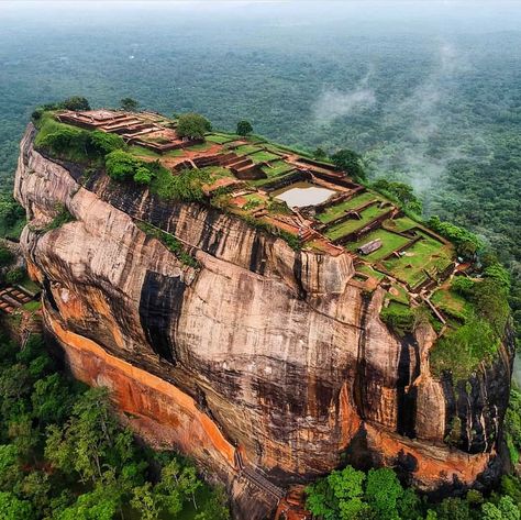 Sigiriya also known as “Sinhagiri” or “Lion’s Rock” is an ancient rock fortress situated in Sigiriya town near the town of Dambulla in the Central Province of Sri Lanka. Sigiriya rock is about 200 meters in height and is a UNESCO listed World Heritage Site. The rock has great historical and archaeological significance and is widely known as the eighth wonder of the world. #travel #history #hiking #ancient #traveltips #sridevi #travelphotography #traveller #traveling #archeology Sigiriya Rock, Granite Rock, Ancient Kings, Wonder Of The World, Travel History, South Gate, Ancient Tree, Bird Painting, Historical Monuments