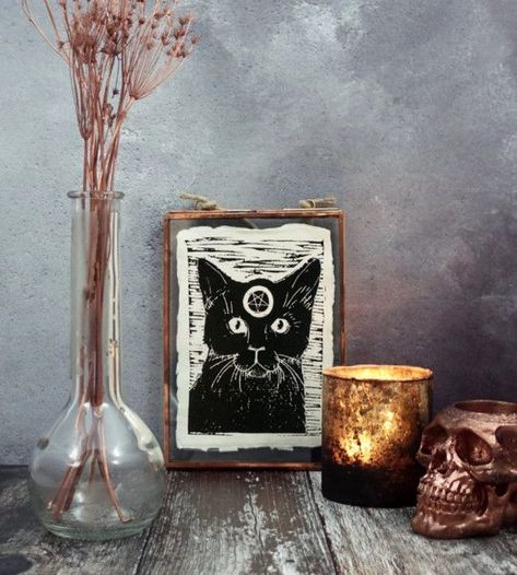 Picture of dried blooms in a vase, a candle, a copper skull and a witch’s familiar art for a cool boho Halloween party Hygge Halloween Decor, Bohemian Halloween Decor, Witch Apartment, Apothecary Vibes, Sewn Pillows, Bohemian Halloween, Familiar Art, Witch's Familiar, Gothic Bohemian