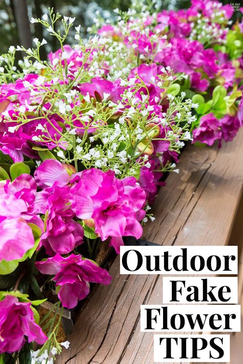 Fake flowers are the way to go if you want fuss free deck railing and flower boxes accenting your home's exterior. Follow these outdoor fake flower tips for nice arranging and to lessen fading from the sun. Window Boxes Ideas Artificial, Faux Flowers Window Boxes, Outdoor Fake Floral Arrangements, Fake Flowers For Front Porch, Fake Flowers On Porch, Fake Flower Planter Boxes, Fake Flowers In Planters, Fake Plants Front Yard, Fake Garden Plants