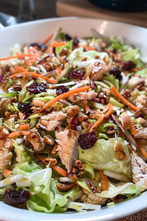 Enjoy a quick and flavorful Homemade Asian Chicken Cranberry Salad with crunchy coleslaw, juicy chicken, and a tangy-sweet dressing. Perfect for any meal! Chicken Cranberry Salad, Asian Salads, Crunchy Coleslaw, Chicken Cranberry, Chinese Salad, Salad With Cranberries, Cranberry Chicken Salad, Cranberry Chicken, Chinese Chicken Salad