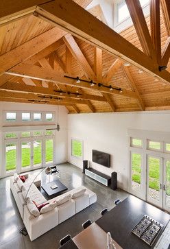 Photo credit: Vanni Archive/Architectural Photography | open concept living room with exposed beam ceiling | white sectional sofa | white walls | concrete floors | living room ideas | home decor Truss Ceiling, Track Lighting Living Room, Exposed Trusses, Living Room New York, Wood Truss, Roof Ideas, Open Ceiling, Attic Renovation, Ceiling Lights Living Room