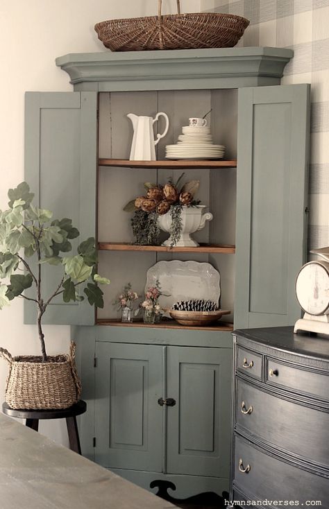 This primitive corner cabinet has been in my family for generations and is over 100 years old! I recently painted it and love how it turned out. #hymnsandverses #antiquecabinet #antiquecornercabinet #paintedcabinet #greencabinet #greenpaint #shadesofgreenpaint #paintingfurniture #furniturepainting #paintedfurniture #primitivefurniture Redone Corner Cabinet, Chalk Paint Corner Cabinet, Paint Cabinet, Corner Cabinet For Dining Room, Corner Cabinet Paint Ideas, French Country Corner Cabinet, Vintage Corner Cabinet Makeover, Corner Cupboard Decorating Ideas, Modern Corner Cabinet Ideas Living Room