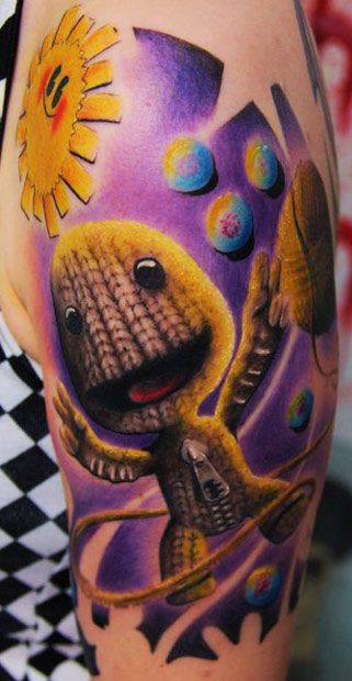 Cartoon Tattoo by Florian Karg | Tattoo No. 2600 Playstation Tattoo, Sack Boy, Little Big Planet, Circle Tattoo, Planet Tattoos, Back Of Neck Tattoo, Boy Tattoos, Sun Tattoo, Cartoon Tattoos