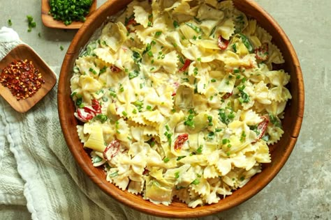 Bow tie pasta salad in wood bowl with kitchen towel underneath Joanna Gaines Pasta Salad, Joanna Gaines Bow Tie Pasta, Joanna Gaines Greek Pasta Salad, Friendsgiving Casserole Joanna Gaines, Chinese Deserts, Tomato Pasta Recipe, Bow Tie Pasta, Marinated Vegetables, Salmon Potato