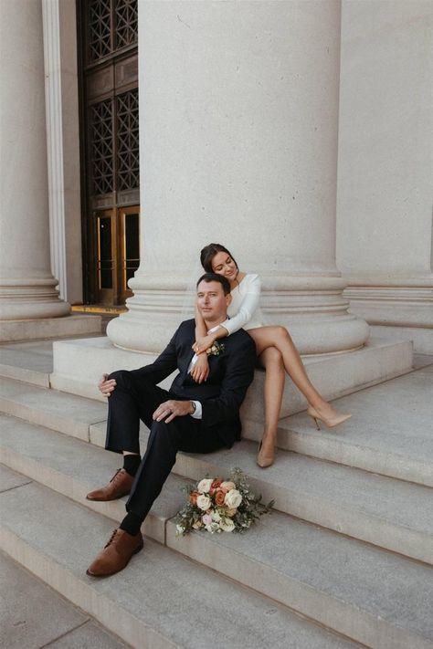 Bride and groom posing for editorial style elopement photos at the Denver Probate Courthouse in Downtown Denver, CO. Bride is wearing a short off shoulder dress by Sarah Seven, with a modern fall bridal bouquet by Beet & Yarrow. Short Off Shoulder Dress, Courthouse Marriage, Editorial Elopement, City Engagement Pictures, City Hall Wedding Photos, Courthouse Wedding Photos, Engagement Picture Outfits, Wedding Portrait Poses, Cute Engagement Photos