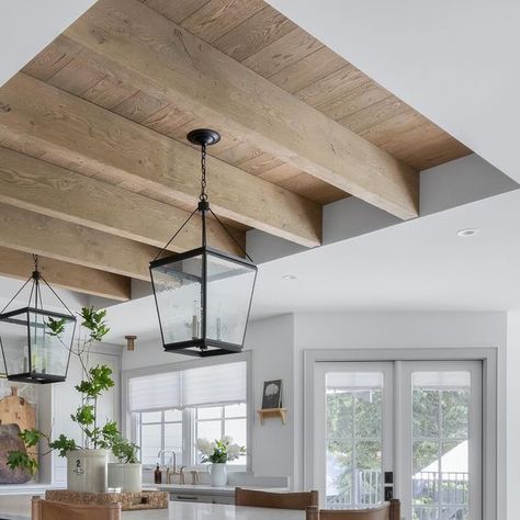 ANDREW FRIESEN • SU CASA DESIGN INC. on Instagram: "Who says you need to settle for less when redesigning your kitchen? ⁠🤔 ⁠ We would have loved a high ceiling throughout our kitchen (who wouldn’t), but it wasn’t in the budget to raise the roof! So, we opted for a more budget-friendly hack that turned a design challenge into a real showstopper (a Grand ARDA award-winning showstopper at that 🤩)⁠ ⁠ For our kitchen renovation, we created a boxed ceiling that extends just over the island, exposing the trusses and wrapping them in wood to look like beams. ⁠ ⁠ It’s a DIY dream come true that adds a ton of character!!⁠ PLUS, it’s become the highlight of the home and one of the favourite places to hang out!⁠ ⁠ Home Design and Interiors @sucasadesign⁠ Home Build @coppercreekhomes⁠ Home Photograph Raised Kitchen Ceiling, Vaulted Ceiling Into Flat Kitchen, Faux Beams Kitchen Ceiling, Angled Ceiling Kitchen, Kitchen With Beams On Ceiling, Ceiling Beams Kitchen, Beams In Tray Ceiling, Oak Ceiling Beams, Kitchen With Beams