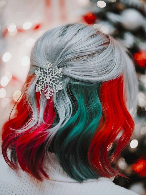 Silver hair with red and green highlights in a half-up style with a snowflake clip. Christmas Split Dye Hair, Hair Color Ideas Winter Blonde, Christmas Hair Colour Ideas, Christmas Vivid Hair Color, White And Copper Hair, Red And Silver Hair Color Ideas, Crazy Dyed Hair Ideas, Christmas Color Hair, Dark Blonde Hair With Color Peekaboos