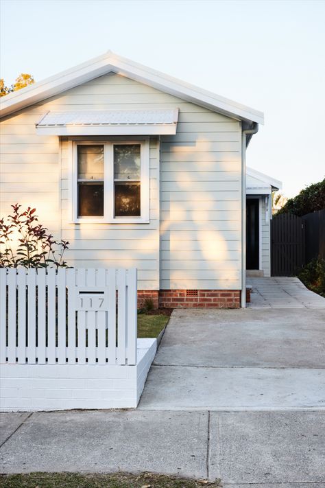 A transformation of a humble Sydney cottage into a modern three bedroom family home. This extensive renovation has breathed life into every corner, with significant replanning to maximise the property inclusions and value. Storage solutions have been meticulously designed and integrated to enhance practicality for this young family Picket Fence House, White Hamptons Fence, Modern Picket Fence, White Picket Fence Uk, Front Picket Fence Australia, Aluminium Picket Fence, White Picket Fence House, White Picket Fence Corner Lot, Reno Kitchen