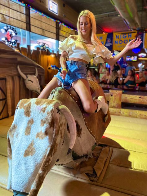 Nashville pub crawl guest riding mechanical bull Female Bull Riders, Bull Riding Chaps Rodeo, Rodeo Bull Riding, Mechanical Bull Riding, John Crimber Bull Rider, Nashville Bars, Mechanical Bull, Bull Riding, Pub Crawl