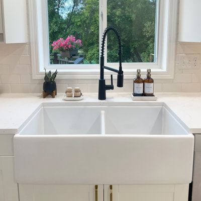 Sometimes a little order can bring things back into balance. The Austen double bowl farmhouse fireclay kitchen sink helps you organize the clean from the dirty by making space for washing and drying dishes at the same time. Our ultra-durable and dense fireclay is fired up to 2100° F and protected with our proprietary finish that safeguards and adds strength. Sinkology Size: 10" H x 36" L x 18" W | Sinkology Austen Fireclay Double Bowl Farmhouse Apron Front Undermount Kitchen Sink & Drain 10.0 H White Farmhouse Sink With White Cabinets, Farmhouse Sink Black Faucet, White Sink Black Faucet, White Shaker Kitchen Cabinets Farmhouse, Double Sink Kitchen, White Farm Sink, Double Farmhouse Sink, Kitchen Sink White, Farmers Sink