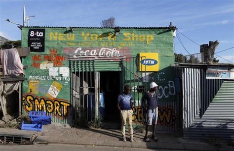 Residents stand outside a spaza convienience shop in Cape Town's Imizamo Yethu township, April 19, 2014. REUTERS/Mike Hutchings Road Reference, Black Art Aesthetic, Spaza Shop, African Art Photography, African Wallpaper, Lucky Dube, Wooden Shack, South African Landscapes, South Africa Photography