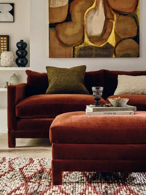 Morroco Living Room, Rust And Blue Interior, Rust Velvet Sofa Living Rooms, Rust Coloured Sofa, Sofa And Ottoman Living Room, Soho Home Living Room, Anthropology Living Room, Ottoman Styling Living Room, Footstools Ideas Living Room