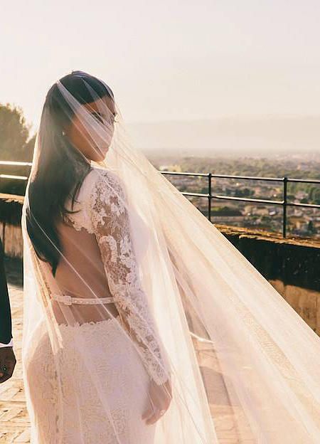 Kim Kardashian wore a couture wedding dress by Givenchy boasting intricate lace long sleeves. Givenchy Wedding Dress, Famous Brides, Iconic Wedding Dresses, Kardashian Wedding, Kim Kardashian Wedding, Famous Wedding Dresses, Couture Wedding Dress, Celebrity Bride, Celebrity Wedding Dresses