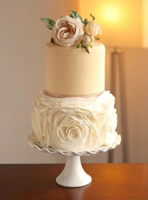 Sophisticated two-tier fondant ivory rosette ruffle wedding cake. Perfect centrepiece for a truly memorable wedding celebration. The rosette detailing, executed with precision and artful design, graces the tiers in a cascading fashion.  The two-tiered structure adds a sense of balance and intimacy to the overall design and the tiers are perfectly stacked.  Cakes can be modified for more height, width and color and more tiers if needed. Coffee Wedding Cake, Shabby Chic Wedding Cake, 2 Tier Wedding Cakes, Rose Gold Wedding Cakes, Ruffle Wedding Cake, Floral Wedding Cake, Classic Wedding Cake, Memorable Wedding, Amazing Wedding Cakes