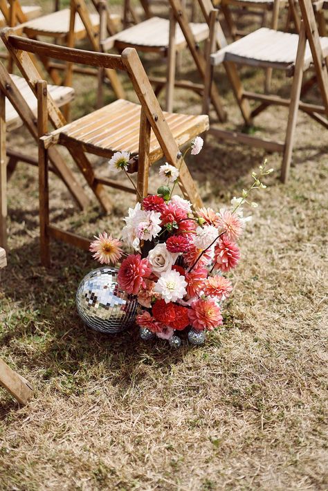 Red, pink, and white wedding flowers with dahlias and roses with disco balls Disco Wedding Aisle, Pink Wedding Aisle, Wedding Theme Outdoor, Disco Ball Wedding Decor, Pink And White Wedding Flowers, Disco Ball Wedding, London Wedding Dress, Disco Ball Decorations, Wedding Themes Outdoor