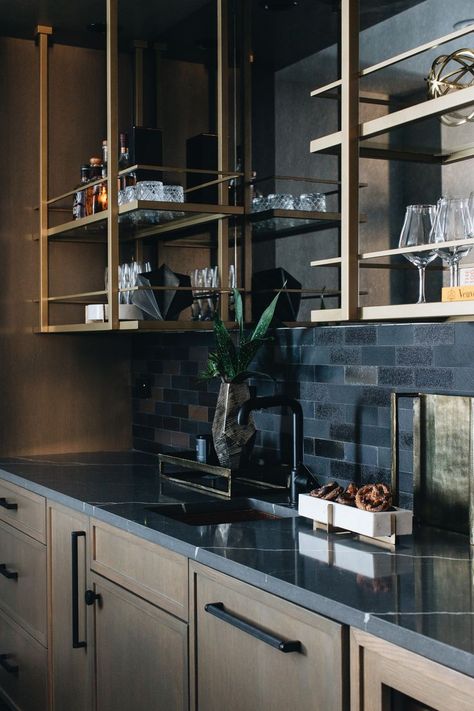 Wet Bar Dark Countertop, Wetbar With Floating Shelves, Metal And Glass Bar Shelving, Bar Backsplash Ideas Open Shelving, Moody Basement Kitchenette, Dark And Moody Basement Bar, Moody Bar Area, Wet Bar Open Shelving, Black And Gold Basement Bar