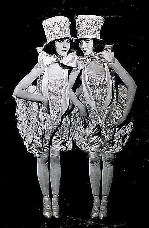 Vintage ca. late 1910′s / early 1920′s photograph of Ziegfeld Follies showgirls the Fairbanks Twins, Madeline and Marion, in a spirited jazz age costume view. Though not actually twins, the sisters were a fixture in vaudeville, early silent film, and become featured stars in the Ziegfeld Follies and Midnight Frolic revues. (by Culver Pictures Inc., NY) / src: Grapefruit Moon Gallery Busby Berkeley, Ziegfeld Follies, Ziegfeld Girls, Flower Costume, Burlesque Costumes, The Sisters, Jazz Age, Old Hollywood Glamour, Silent Film