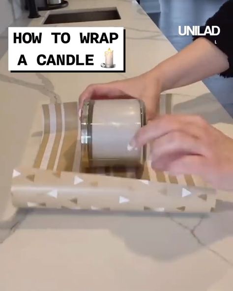 How to wrap a candle | candle | Finally! A way to wrap a candle without it looking like Christmas cracker 😂 | By GOODLAD Wrap A Candle For Christmas, Candles Wrapping Ideas, Gift Wrapping A Candle, How To Wrap Candles For Christmas, How To Wrap A Jar With Wrapping Paper, Wrapping Candles For Christmas Gifts, How To Wrap A Candle For Christmas Gift, Gift Wrap Candle, How To Wrap Candles Gift Packaging Ideas