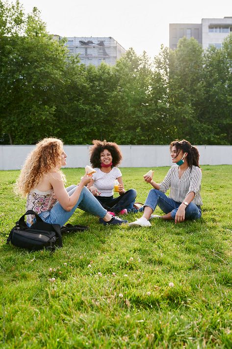 Three diverse young female friends with protective face masks around their necks talking during a picnic together in a city park People In Park Photography, Three People Sitting Together, Friend Dynamic, Madrid Photoshoot, People In Park, Stock Photography Ideas, Figure Drawing Practice, Friends Talking, Park Photoshoot