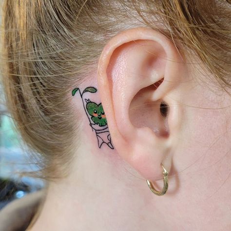 Sharing with you another Legend of Zelda-themed tattoo -- this time done by @thistlekae!! This little korok piece as an ear ornament is so cute!⁠ ⁠ "Ya ha ha! You found me!⁠ ⁠ In love with this wee korok peeking out from behind Nicole's ear. Thanks for the trust!⁠ ⁠ And a plug for Nicole - if you are in need of Thai or regular massage, hit her up nicolejangula.rmt 🤩" - Kathleen⁠ Breathe Of The Wild Tattoo, Subtle Zelda Tattoo, Korok Tattoo Wind Waker, Tattoo Ideas Zelda, Zelda Dragon Tattoo, Breath Of The Wild Tattoo, Zelda Ocarina Of Time Tattoo, Korok Tattoo, Zelda Tattoo Ideas