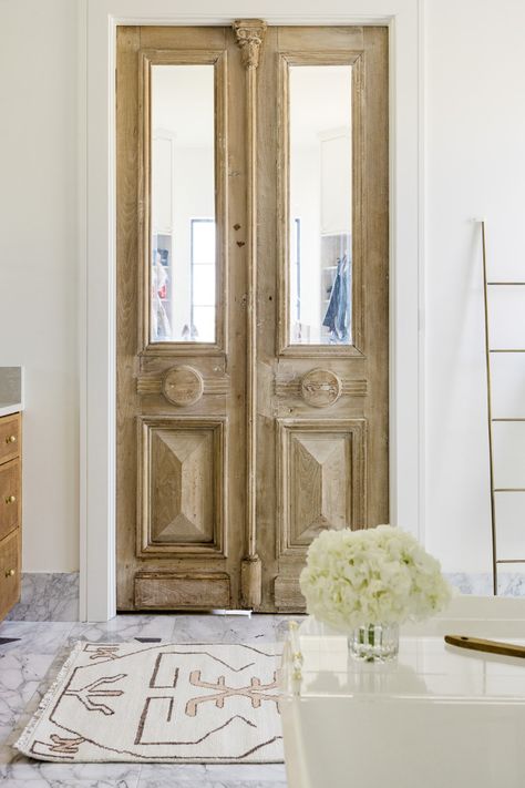 Add charm with restored antique doors Antique Double Doors, Vintage Closet Doors, Parisian Foyer, Bathroom Doors Ideas, Interior Doors With Glass Panels, Bathroom French Doors, Vintage Door Decor, Wood Closet Doors, Folding Closet Doors