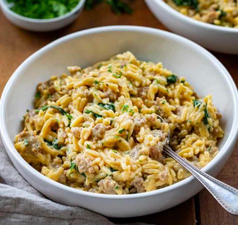 One Pot Sausage Orzo is a creamy dish with Italian sausage, orzo pasta, and fresh spinach with added garlic, onion, and a touch of red pepper flakes. And, since it is a one-pot meal, it is simple to prepare and clean up! This will surely be a family favorite, perfect for a weeknight dinner. Italian Sausage Orzo, Sausage Orzo, One Pot Sausage, Orzo Spinach, Spicy Sausage Pasta, Creamy Orzo, Pasta Fresh, Orzo Recipe, Orzo Recipes