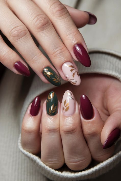 Embrace the beauty of the season with these fall nail ideas featuring mesmerizing gel nails adorned with intricate autumn leaves. The rich hues of red, orange, and gold encapsulate the essence of fall, making your nails a true seasonal statement. Perfect for cozy gatherings or weekend outings, these stunning gel nails will elevate your style while keeping your tips chip-free and glossy. Discover the magic of these fall nail ideas! #FallNailIdeas #GelNails #AutumnNails #NailArt Short Almond Nail Art Fall, Fall Leaf Designs For Nails, Colourful Autumn Nails, Red And Gold Design Nails, Gold Leaves Nails, Fall Jewel Tone Nails, Fall Leaves Nails Design, Olive And Gold Nails, Fall Nails Leaves Autumn