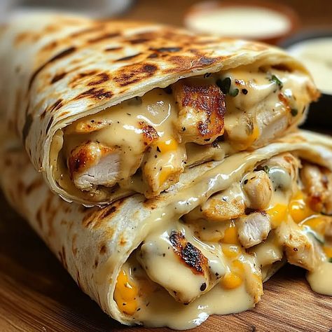 If you’re looking for a quick, easy, and flavor-packed meal, look no further than these Cheesy Garlic Chicken Wraps. ... Read more Sides For Chicken Wraps, Chicken Philly Wrap, Burrito Ideas For Lunch, Baked Chicken Wraps, What To Make With Smoked Chicken, Wrap Dinner Ideas, Dinners For Husband, Chicken Nuggets Meal, Lunch Recipes Chicken