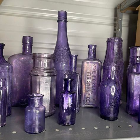 A set of 16 antique purple bottles and jars of varying sizes. Most pieces are free from chips and cracks, but most have a white haze to the bottle. I have been somewhat successful with using petroleum jelly in removing some of the haziness. California Fig Syrup bottle, Columbia Catsup bottle are a couple of the ones being offered in this healthy-sized collection.  A little background info on these purple bottles. Some, possibly all of these bottles were not originally purple / Amethyst. The colo Purple Bottles, Fig Syrup, Purple Bottle, Purple Gothic, Syrup Bottle, Purple Bedrooms, Antique Glass Bottles, Rustic Traditional, Purple Decor