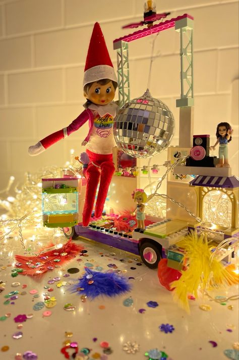 Lego Sparkles Feathers Small diaxo ball Fairy lights Elf Barbie Jacket #elfontheshelf #elfontheshelfideas Barbie Elf On A Shelf, Elf On The Shelf Disco Party, Elf On The Shelf With Barbie, Elf On The Shelf Barbie, Elf On The Shelf Party, Elf 2024, Barbie Jacket, Elf On The Shelves, Elf Activities