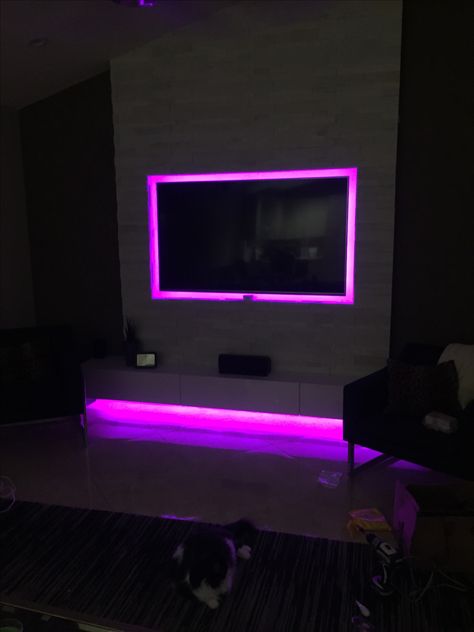 LED entertainment wall. RGB LED strips on back of tv and at the bottom of the custom floating cabinet. Led Light Tv Wall, Tv Wall Decor Led Lights, Floating Tv Stand With Led Lights, Led Lights Around Tv, Tv With Led Lights Behind, Led Lights Behind Tv, Lights Behind Tv, Led Tv Wall, Built In Tv Wall Unit