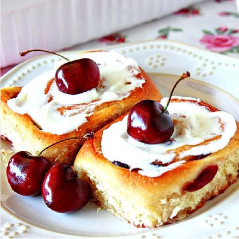 This homemade Cherry Sweet Rolls recipe makes light-as-air yeasty breakfast buns with delicious cherry flavor along with a thick topping of sweet almond glaze. #cherryrecipe #cherrybuns #cherrysweetrolls #sweetrolls #sweetbreakfastrolls #sweetbrunchrecipe #cherries #almondglaze #yeastrolls #sweetyeastrolls #homemadesweetbuns #creamcheeseglaze #kudoskitchenrecipes Pioneer Woman Glazed Cherry Almond Rolls, Cherry Sweet Rolls Recipe, Cherry Sweet Rolls, Brunch Danish, Cherry Rolls, Sweet Rolls Recipe, Almond Cream Cheese, Breakfast Buns, Pastry Decoration