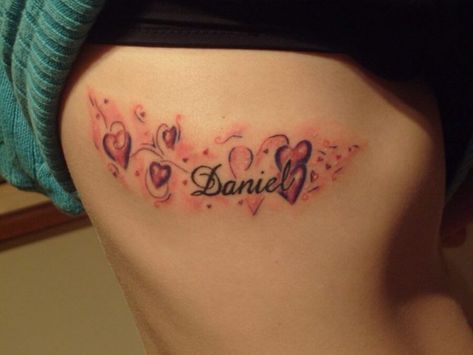 Name tattoos for women doesn't always have to be just text or monochromatic. Check out these creative examples for your reference. Boyfriend Name Tattoo Ideas, Boyfriend Name Tattoo, Name Tattoos Designs, Boyfriend Name Tattoos, Tattoos About Mom, Tattoos About Growth, Magic Tattoo Ideas, Tattoos Dainty, Name Tattoo Ideas