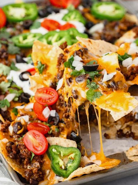 This Loaded Nachos Recipe is like a fiesta for your taste buds! Crispy tortilla chips are dripping with gooey cheddar cheese, juicy ground beef, black beans, sour cream, olives and jalapeños. Every chip tastes like you've won the snack lottery! Nacho Chips Recipe, Bean Nachos Recipe, Ground Beef Nachos, Tortilla Nachos, Loaded Nachos Recipe, Nachos Recipe Beef, Bean Nachos, Nachos Cheese Dip, Corn Salsa Recipe