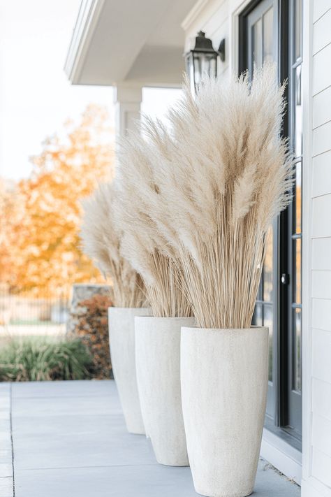 tall concrete planters with pampas grass on a front porch Pompass Grass Tall Floor Vase, Grass In Planters, Tall Concrete Planters, Tall Pampas Grass Decor, Wooden Outdoor Table, Table Fall Decor, Luxe Home Decor, Fall Front Porch Ideas, Grass Wreath