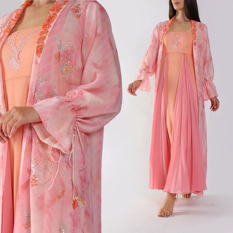 This peach-embellished Bisht Abaya is so unique and chic, full of details and tones of orange, the long puffed sleeves give a super stylish look.⁠ ⁠ Discover the full @Moonoir collection at ELILHAAM.COM✨ Sweet As A Peach, Colorful Palette, Modest Wear, Flowy Maxi Dress, Modern Women, Long Puff Sleeves, Puffed Sleeves, Online Fashion Stores, Modest Dresses