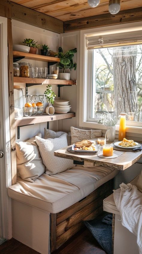 Cozy breakfast nook with natural sunlight, plush cushions, wooden table with breakfast spread, rustic shelves with plants and kitchen essentials. Breakfast Bench, Breakfast Nook Bench, Breakfast Spread, Starting Fresh, Cozy Breakfast, Rustic Wooden Shelves, Cozy Breakfast Nook, Dining Room Cozy, Home Decor Baskets