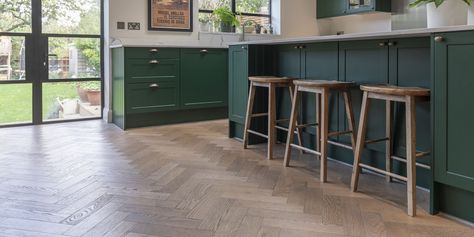 Kitchen floors step design in Kingston home | Deco Parquet Frozen Umber Herringbone Wood Floor Kitchen, Herringbone Floor Kitchen, Kitchen Herringbone Floor, Open Plan Kitchen Design, Plan Kitchen Design, Herringbone Kitchen, Green Kitchen Designs, Dark Green Kitchen, Large Open Plan Kitchens