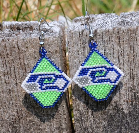 Seattle Seahawks Earrings. 12. Football NFL. GO HAWKS! by CONBONSCREATIONS on Etsy https://www.etsy.com/listing/549166547/seattle-seahawks-earrings-12-football Brick Stitch Football, Steelers Beaded Earrings, Lsu Beaded Earrings, Seattle Seahawks Beaded Earrings, Seahawks Beaded Medallion, Seed Bead Patterns Free, Diy Seed Bead Earrings, Native American Beadwork Patterns, Beaded Earrings Native