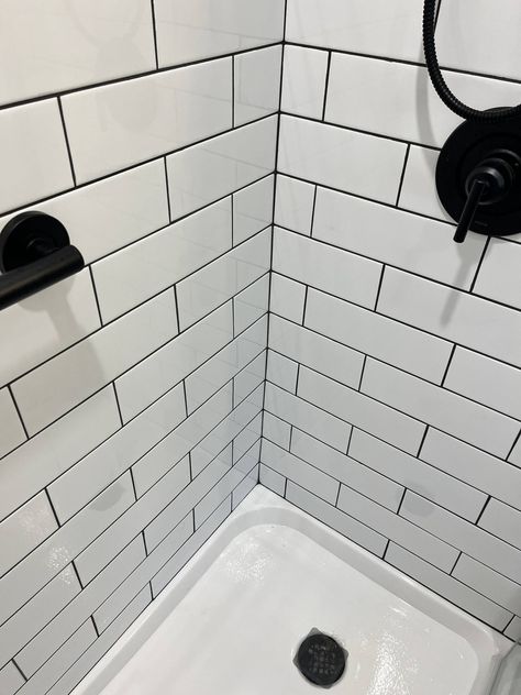 We love how this clients bathroom came out! The white subway tile is such a classic look, but the black grout lines and fixtures give it a bold & modern feel. #transitionaldesign #longislandcontractor #bathroomremodel White Subway Tile Shower Black Grout, White Tiles Black Grout Bathroom, White Tiles Black Grout, White Subway Tile Shower, Black Subway Tiles, Bathroom 2024, Bathroom Upstairs, Subway Tile Showers, Black Grout