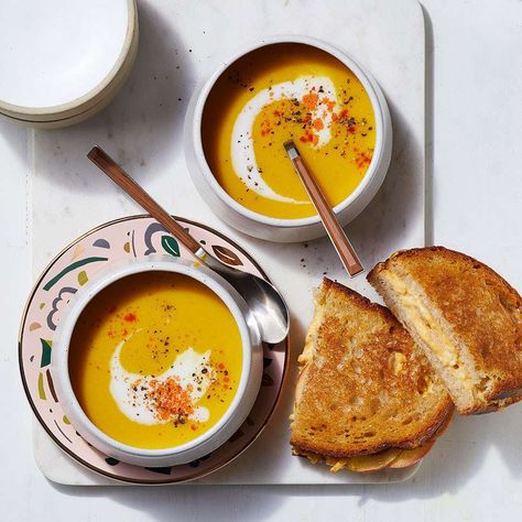 Layering apple slices into grilled cheese sandwiches adds a little crunch to a favorite soup dipper. And creamy butternut squash soup with ginger, cumin and turmeric is a nice change of pace from grilled cheese's usual tomato soup partner. Serve the duo for a comforting and easy weeknight dinner for the family. The soup keeps well in the fridge, so save leftovers for lunch or dinner later in the week. Butternut Squash Soup And Grilled Cheese, Butternut Squash Soup And Sandwich, Squash Soup With Apple, Apple Grilled Cheese, Cream Soups, Magazine Recipes, Nigella Lawson, Butternut Squash Soup, Squash Soup