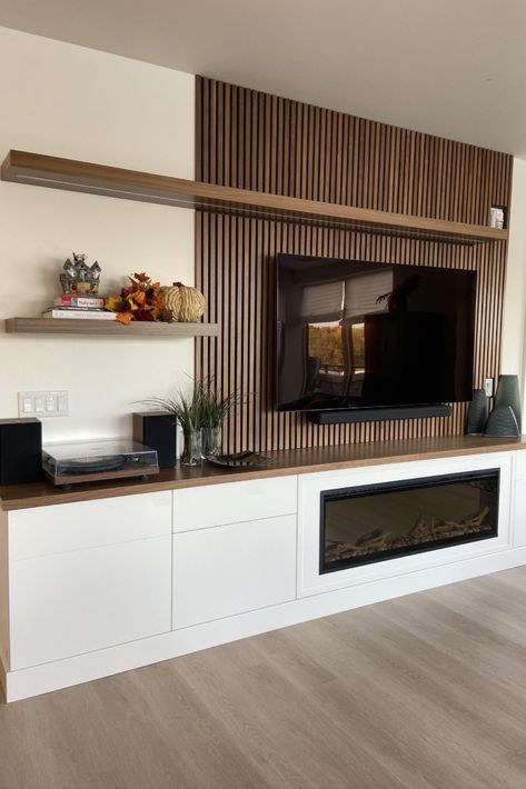 Beautiful custom walnut slat wall for this lovely entertainment unit. Wooden Slat Fireplace Wall, Slat Wall Entertainment Center, Tv Wall With Wood Slats, Slat Wall Fireplace, Modern Entertainment Center Ideas, Slat Wall Living Room, Walnut Slat Wall, Built In Wall Units, Wall Entertainment Center