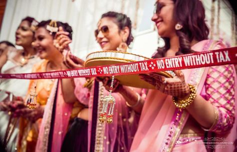 Baraat welcome ideas | sister of the bride with a. and entry banner for the groom | fun Indian wedding ideas Indian Wedding Games, Welcome Ideas, Bride Groom Table, Bride Groom Poses, Bride Entry, Indian Bridesmaids, Bride And Groom Outfits, Desi Wedding Decor, Bride Groom Photos