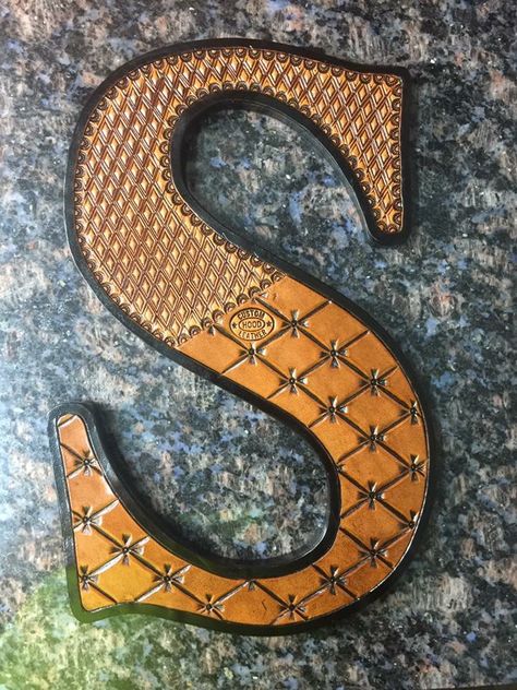 Hand tooled leather letter Tooled Leather Lettering, Leather Motorcycle Mask, Leatherworking Ideas, Leather Letters, Leather Working Projects, Boho Jewellery Necklaces, Saddle Shop, Leather Working Patterns, Leather Tooling Patterns