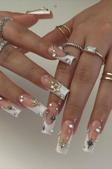 These white French tips by @setsbysenia (IG) exude celestial vibes, adorned with sparkling star gems and rhinestones. The design adds a touch of magic and elegance, perfect for a shimmering, otherworldly look this fall! Discover the season’s top 25 white fall nail ideas, from cozy minimalist designs to chic, polished looks that match any autumn outfit. Get inspired and learn how to create these timeless styles here! French Tips With Gems, Autumn Nail Art, White French Tips, Fall Nail Ideas, Cozy Minimalist, Autumn Nail, White French Tip, White Nail Designs, Sparkling Stars