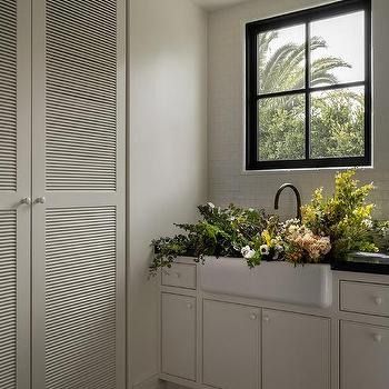 Laundry Room Double Doors Design Ideas Louvered Cabinet Doors, Farmhouse Sink With Black Faucet, Sink With Black Faucet, Louvered Bifold Doors, White Wash Wood Floors, Black Sink Faucet, Arabesque Tile Backsplash, White Quartzite Countertops, Double Closet Doors