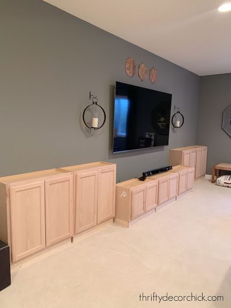 Diy Cheap Built Ins, Unfinished Cabinets Entertainment Center, Wall To Wall Tv Unit, Rustic Wall For Tv, Basement Tv Built In Wall Units, Basement With Half Wall Ledge, Diy Built In Entertainment Center Plans, Tv Built In Wall Unit Diy, Built In Tv Wall Unit Plans